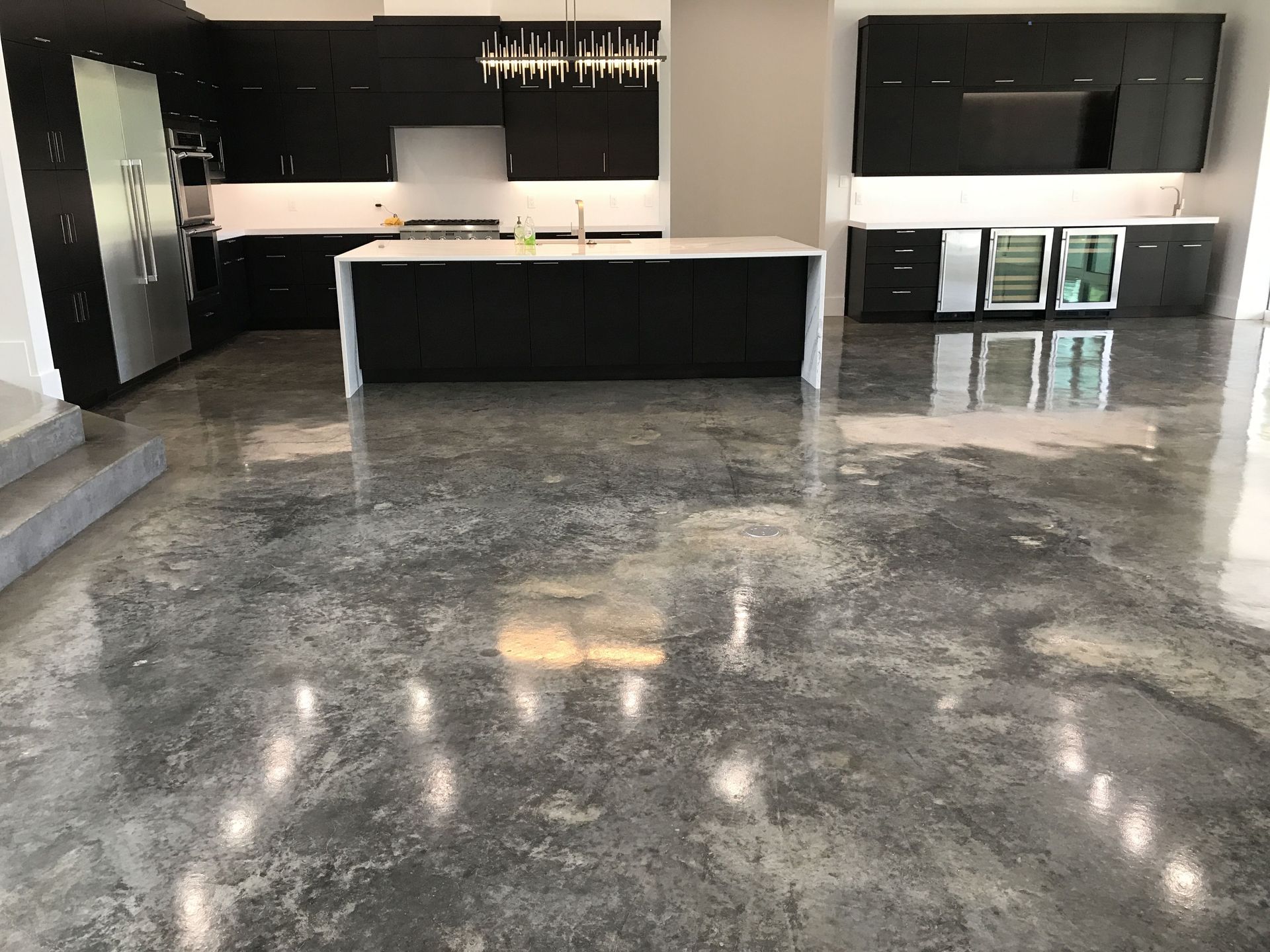 Worker carefully installing vinyl floor covering in a room, ensuring a smooth and precise fit.