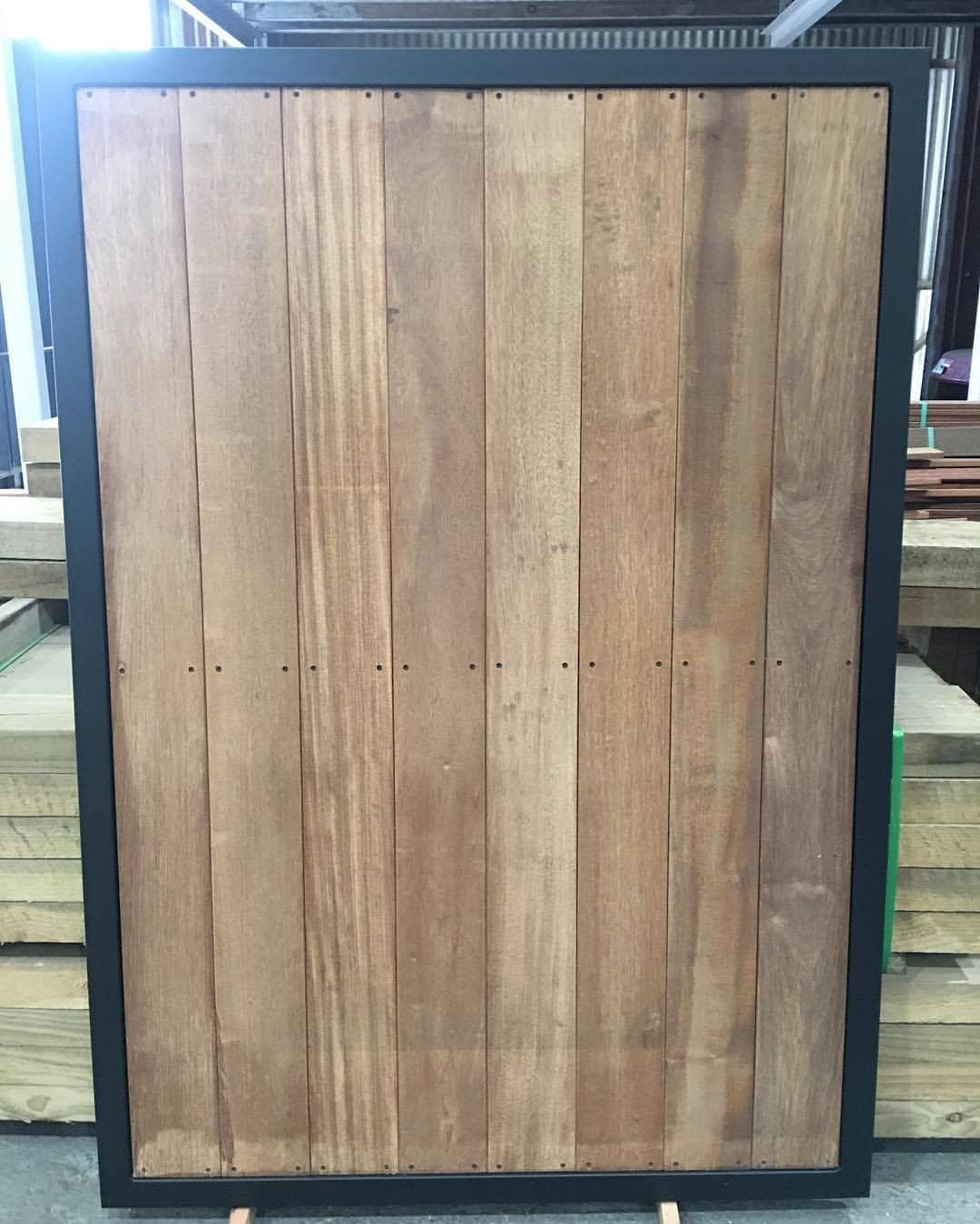 Wooden Panel With Vertical Planks in a Black Frame, Resting on a Stand — Trade Fencing Supplies in Moolap, VIC