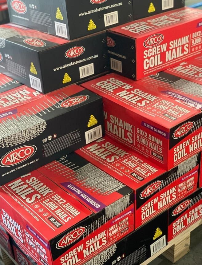 Boxes of Red and Black Screw Shank Coil Nails Stacked on a Pallet — Trade Fencing Supplies in Torquay, VIC