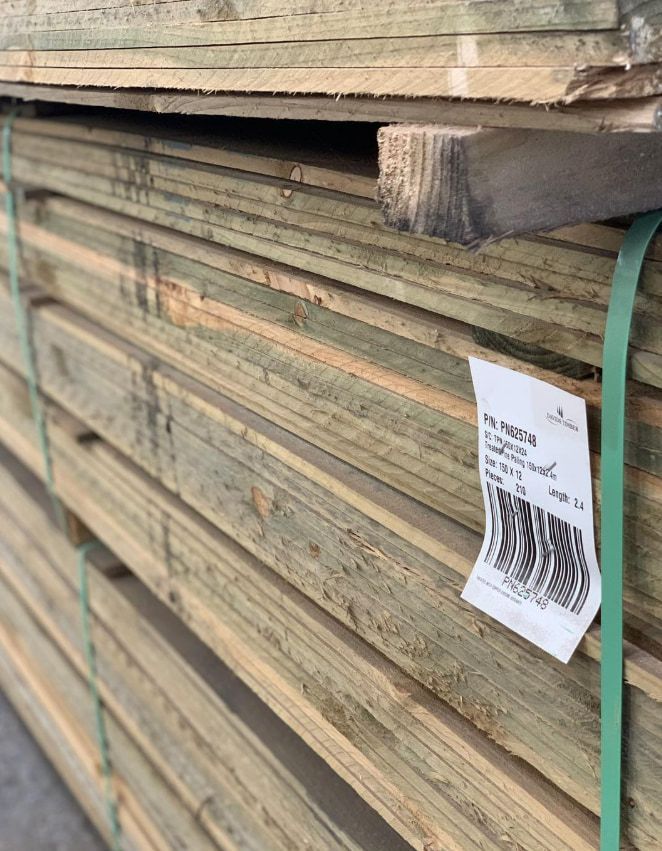 Stack of Green-treated Lumber Boards, Bound With Green Straps — Trade Fencing Supplies in Surf Coast, VIC