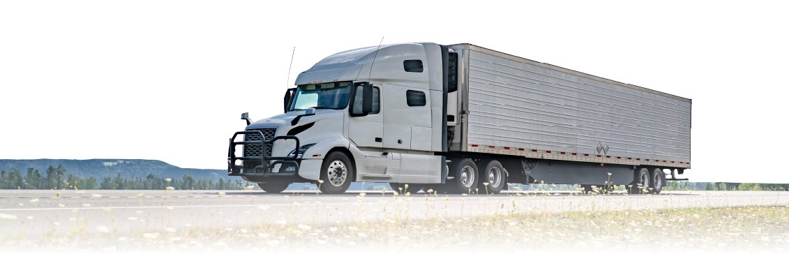 Modern refrigerated semi-truck driving on highway with temperature-controlled trailer.