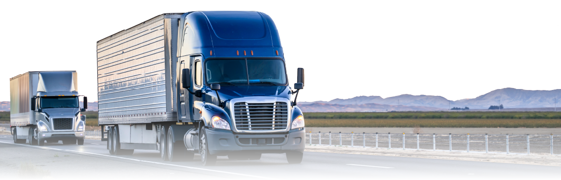 Two freight trucks on highway representing LTL vs FTL shipping options for businesses.