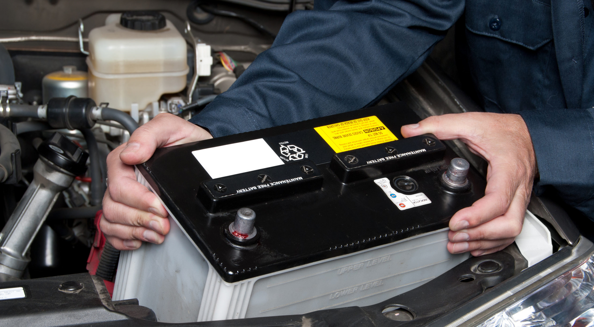 2 cables sitting next to a Mobile Car auto battery replacement being done by a technician.