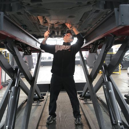 Mechanic is Changing the Vehicle Engine Oil | Kackleberry Automotive Repair and Detail
