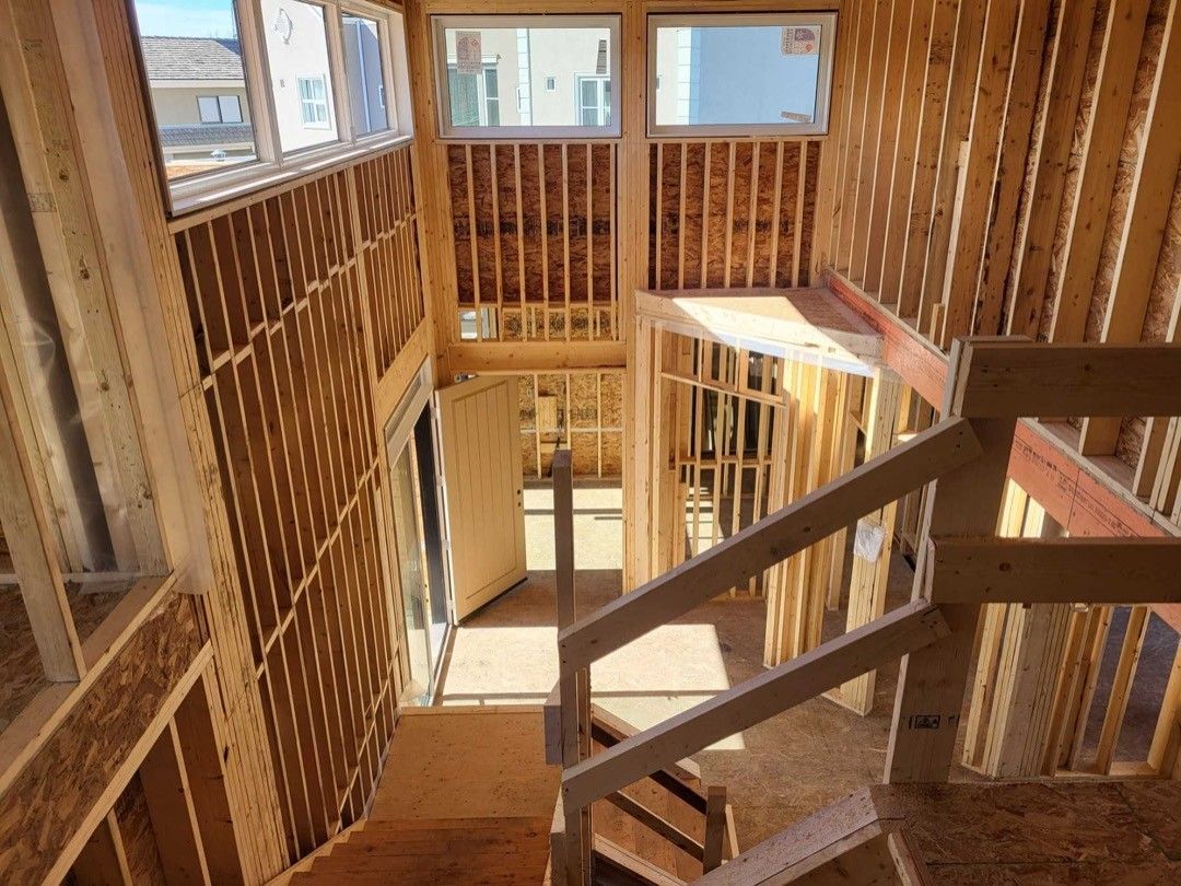 An aerial view of a house under construction with a staircase.