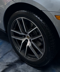 A close up of a jaguar wheel with red brake calipers