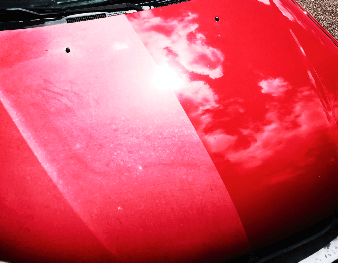 The hood of a red car is shown before and after being cleaned