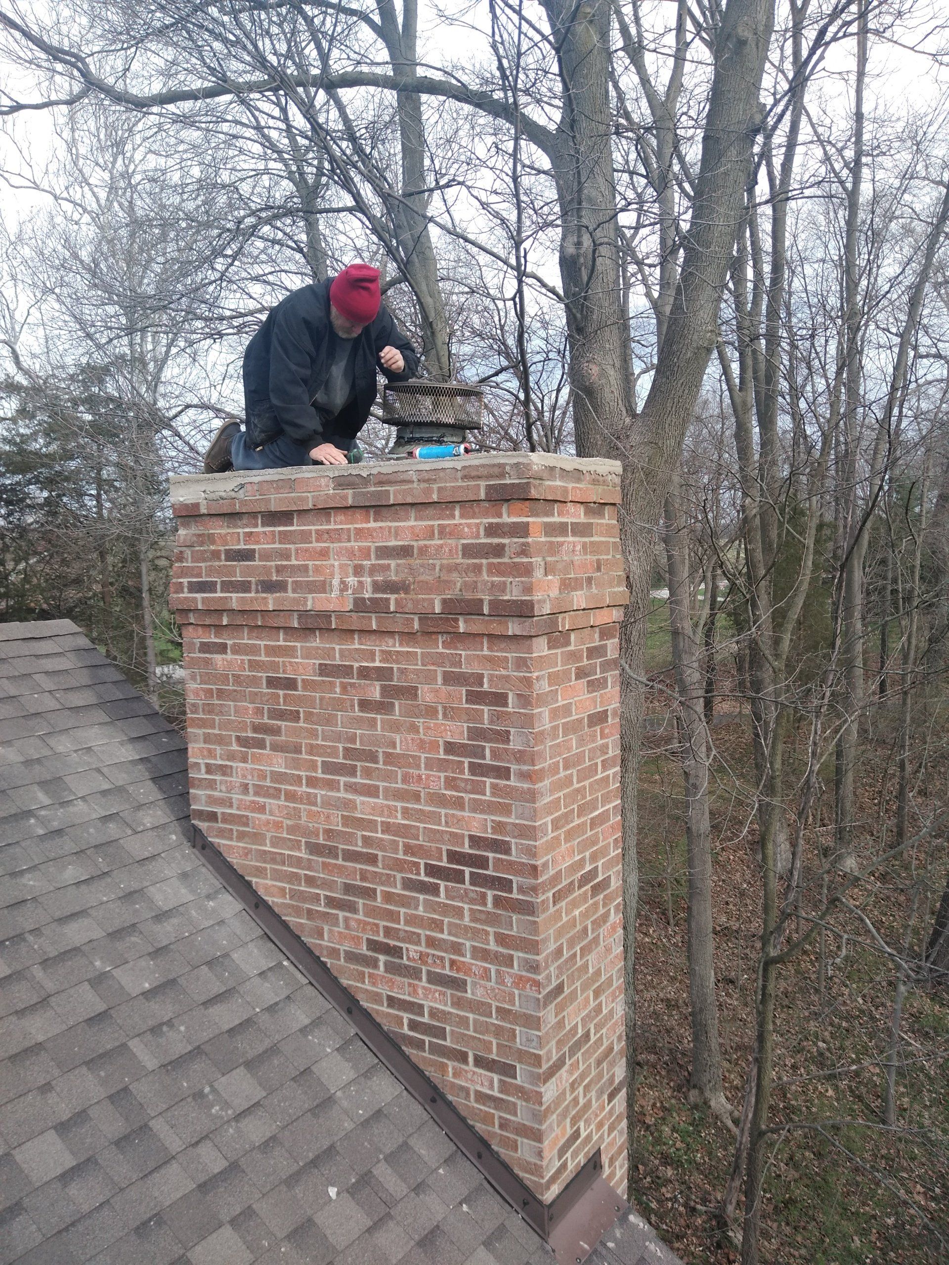 Chimney Sweep servicing residential chimney in Winchester, MA