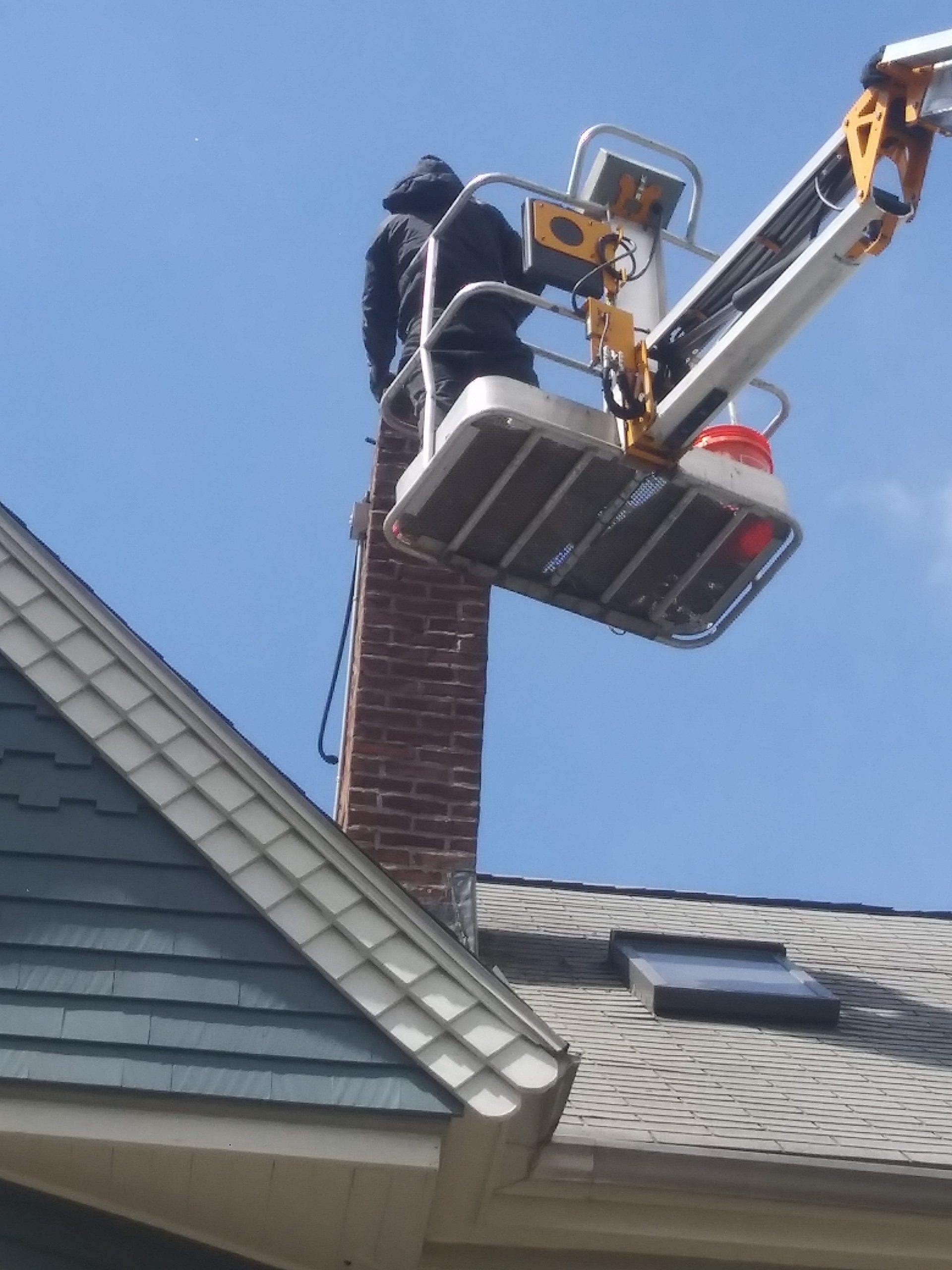 residential chimney repair on lift