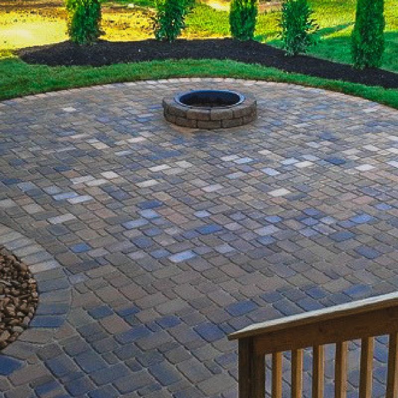 There is a fire pit in the middle of the patio.