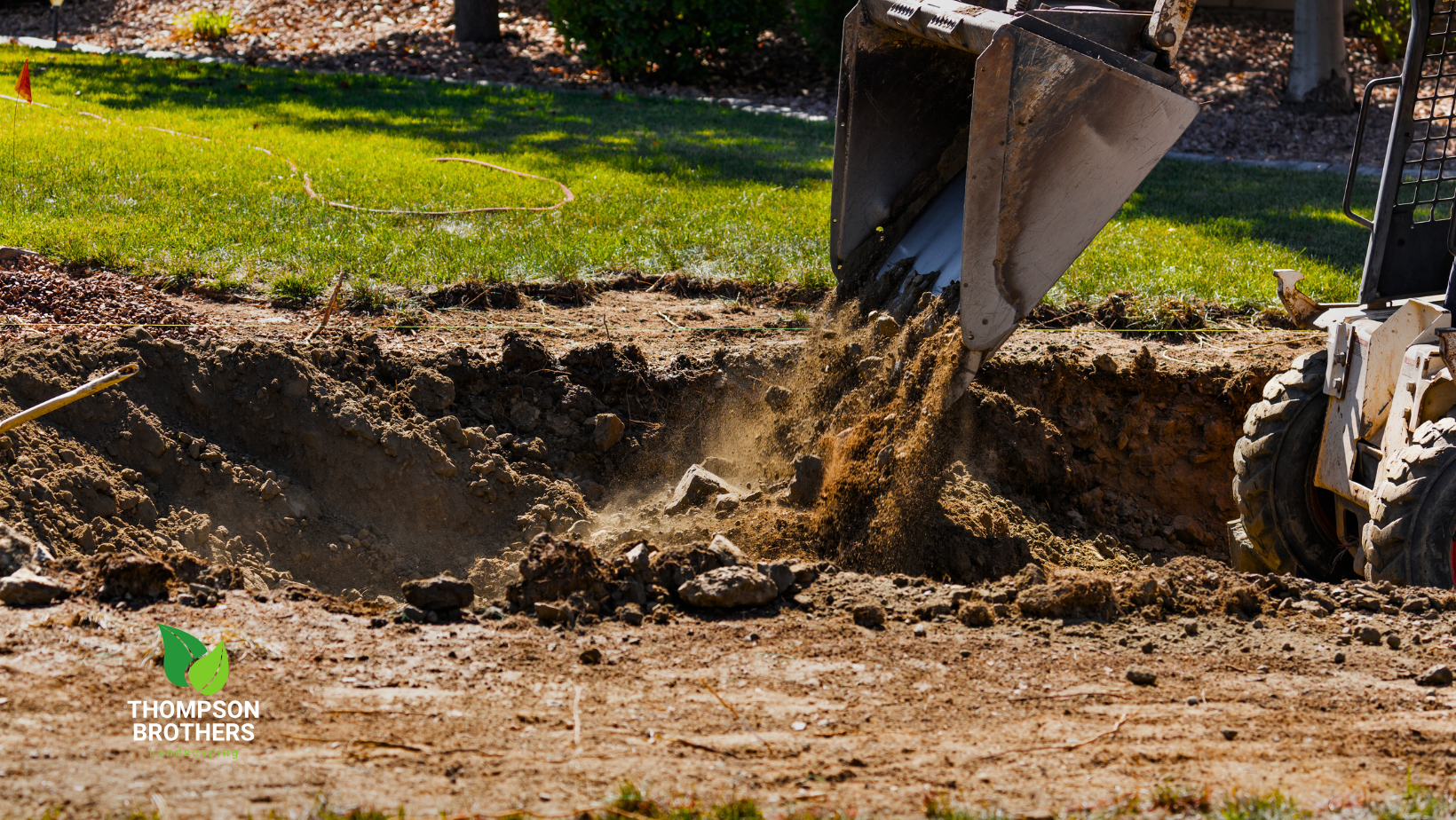 A bulldozer is digging a hole in the ground.