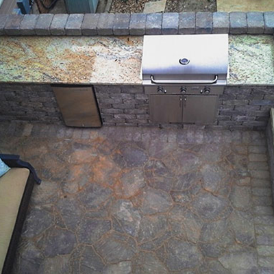 An aerial view of an outdoor kitchen with a grill