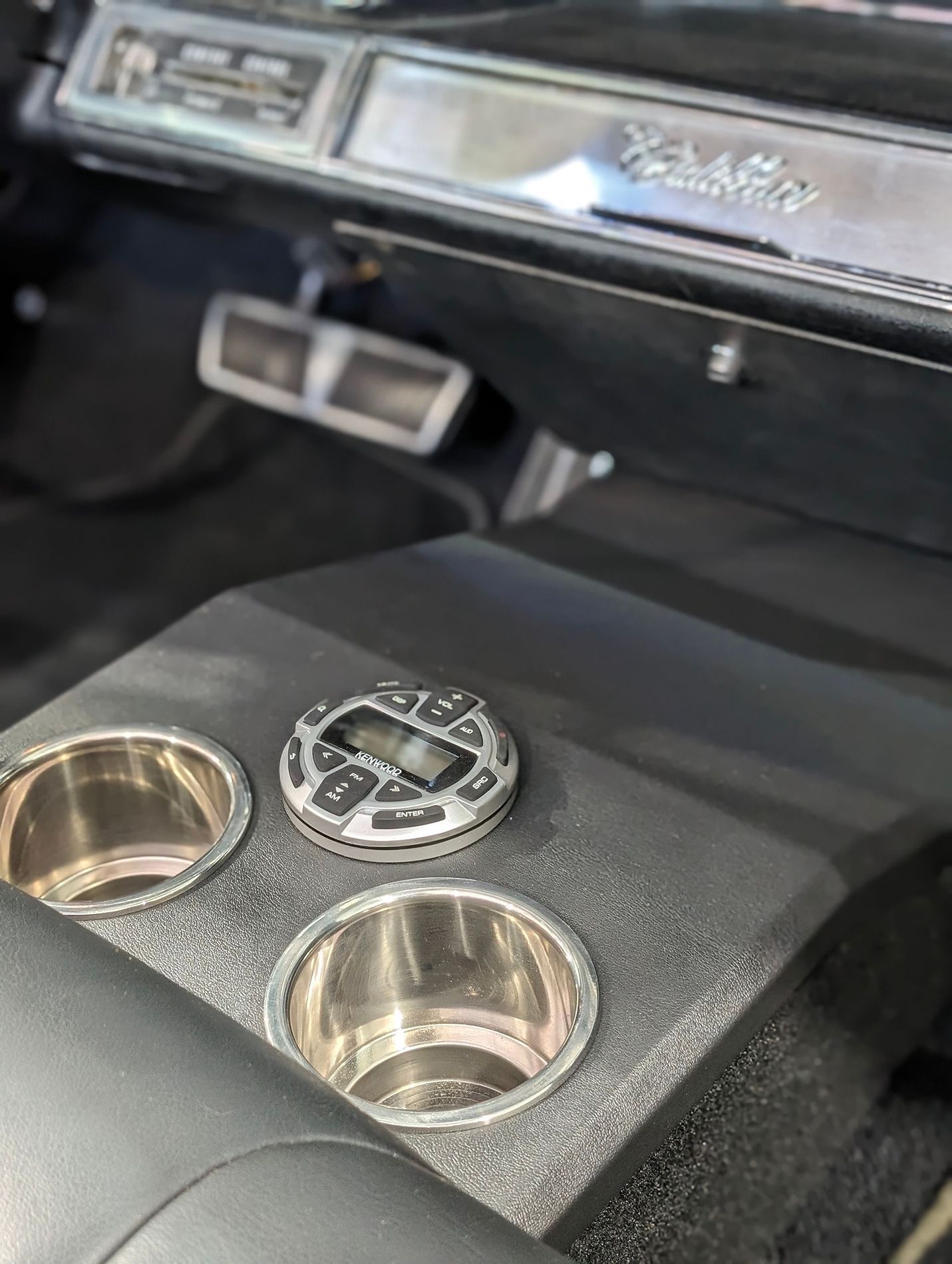A close up of a cup holder in a car.