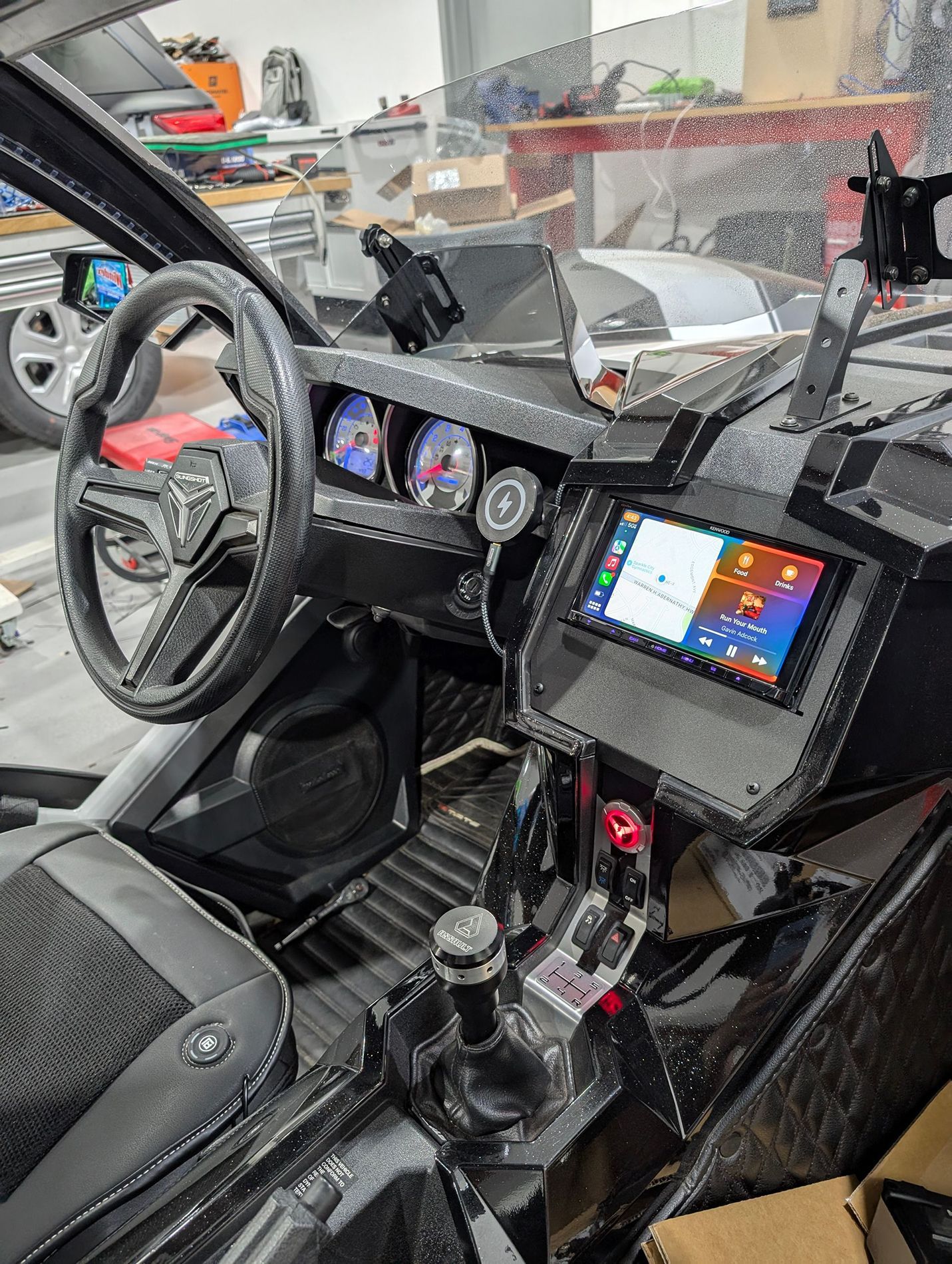 The interior of a car with a steering wheel and dashboard.