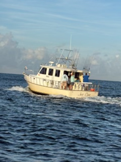A boat is floating on top of a large body of water