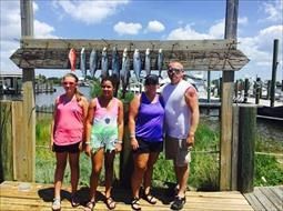 A group of people standing next to each other on a dock.
