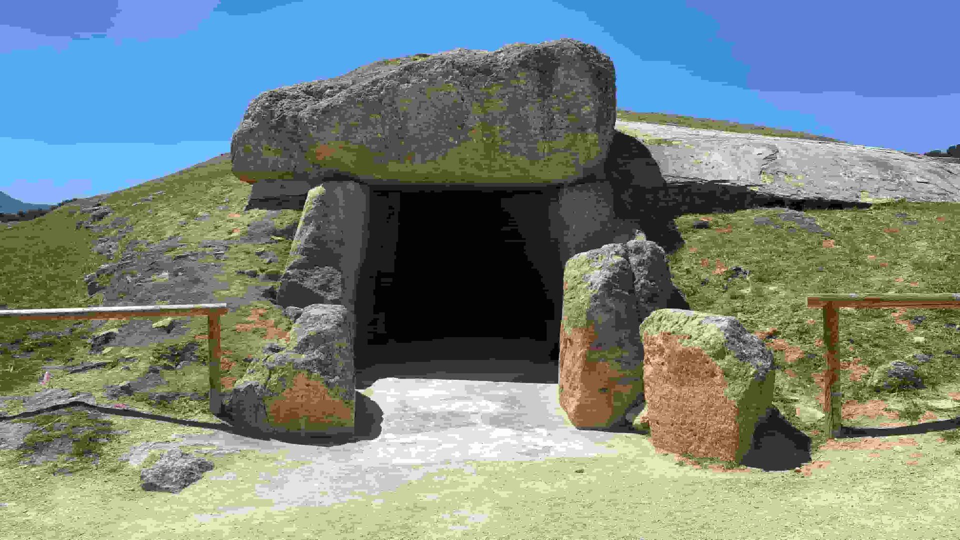 A Dolmen filled with lots of rocks and columns.
