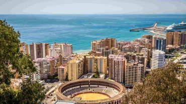 An aerial view of Malaga with a bullring in the foreground.