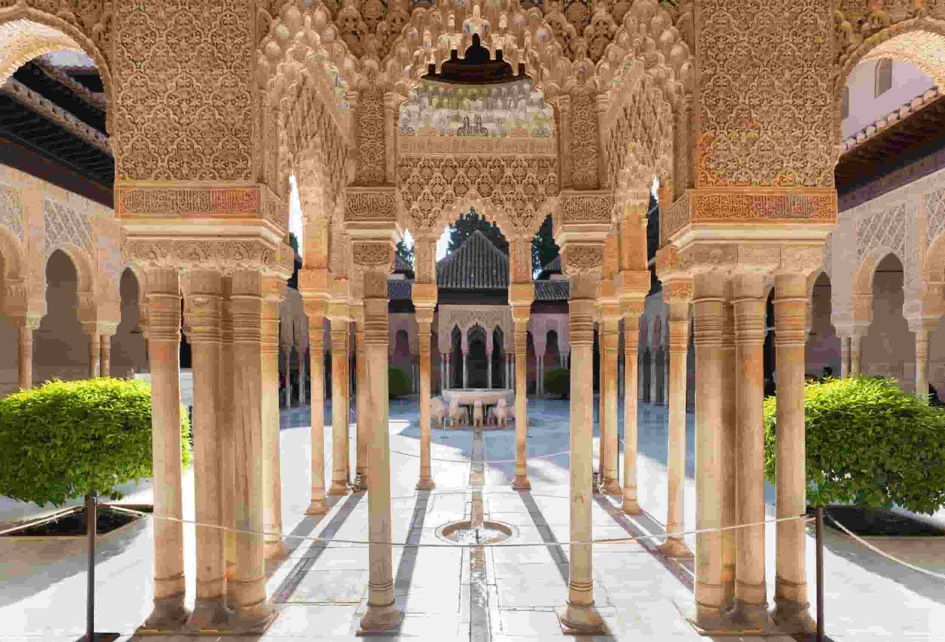 A very ornate building with columns and arches inthe Alhambra.