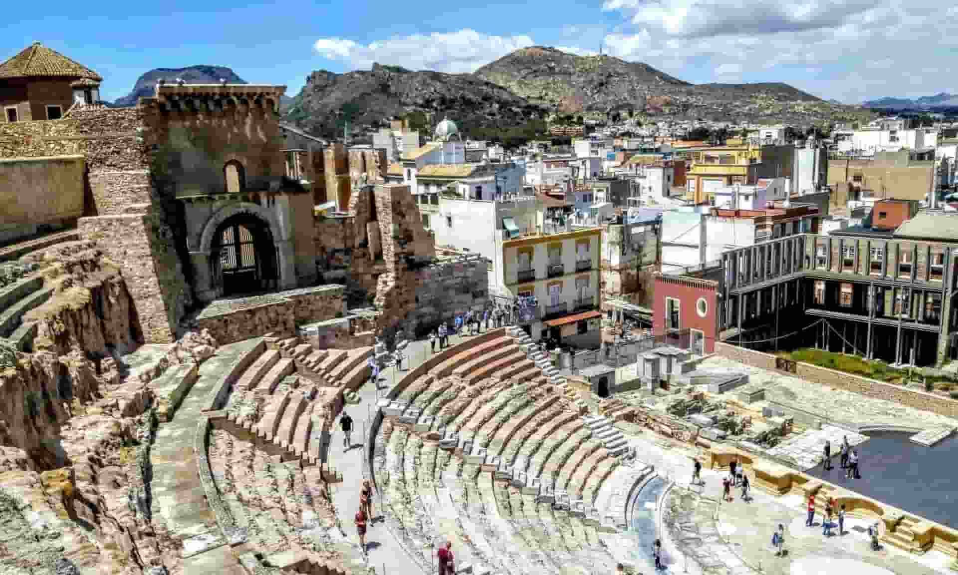 An aerial view of an ancient amphitheater with Cartagena in the background.