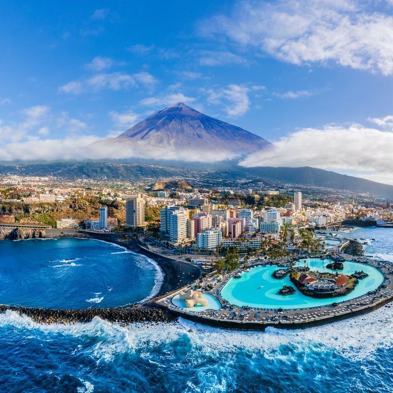 An aerial view of Tenerife with a volcano in the background.