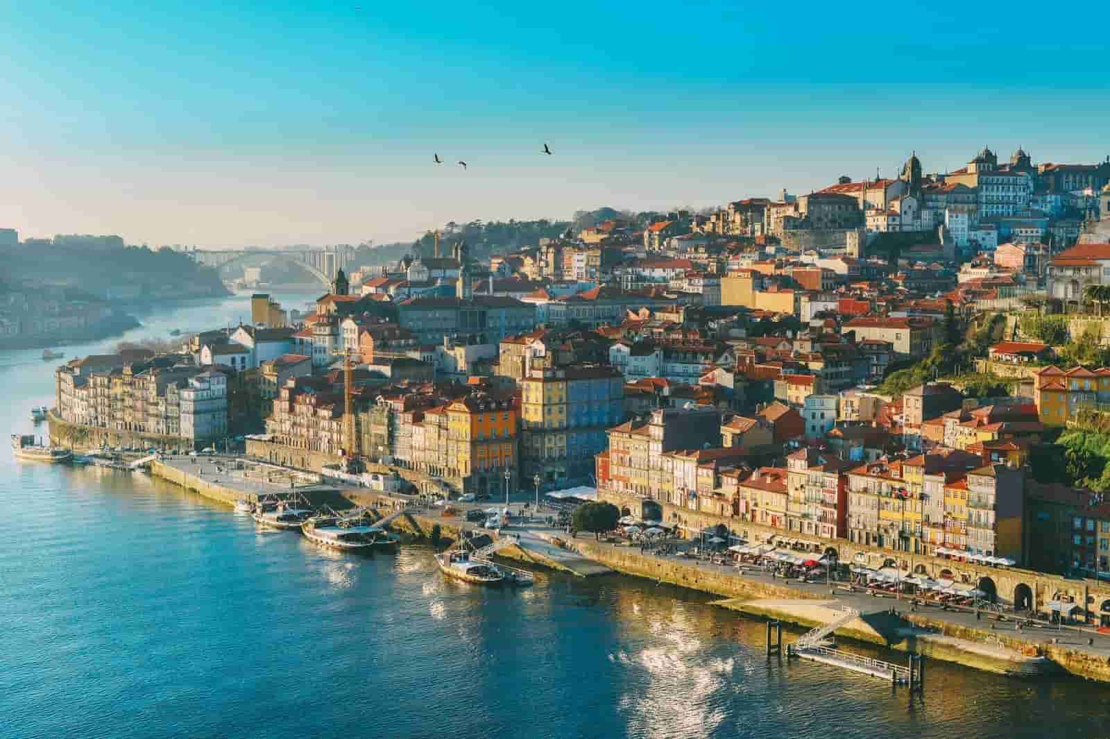 An aerial view of Porto next to a body of water.