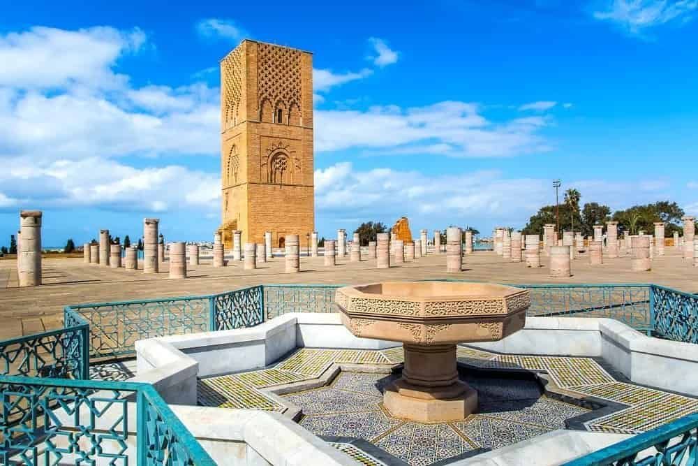 There is a tower in Rabat background and a fountain in the foreground.