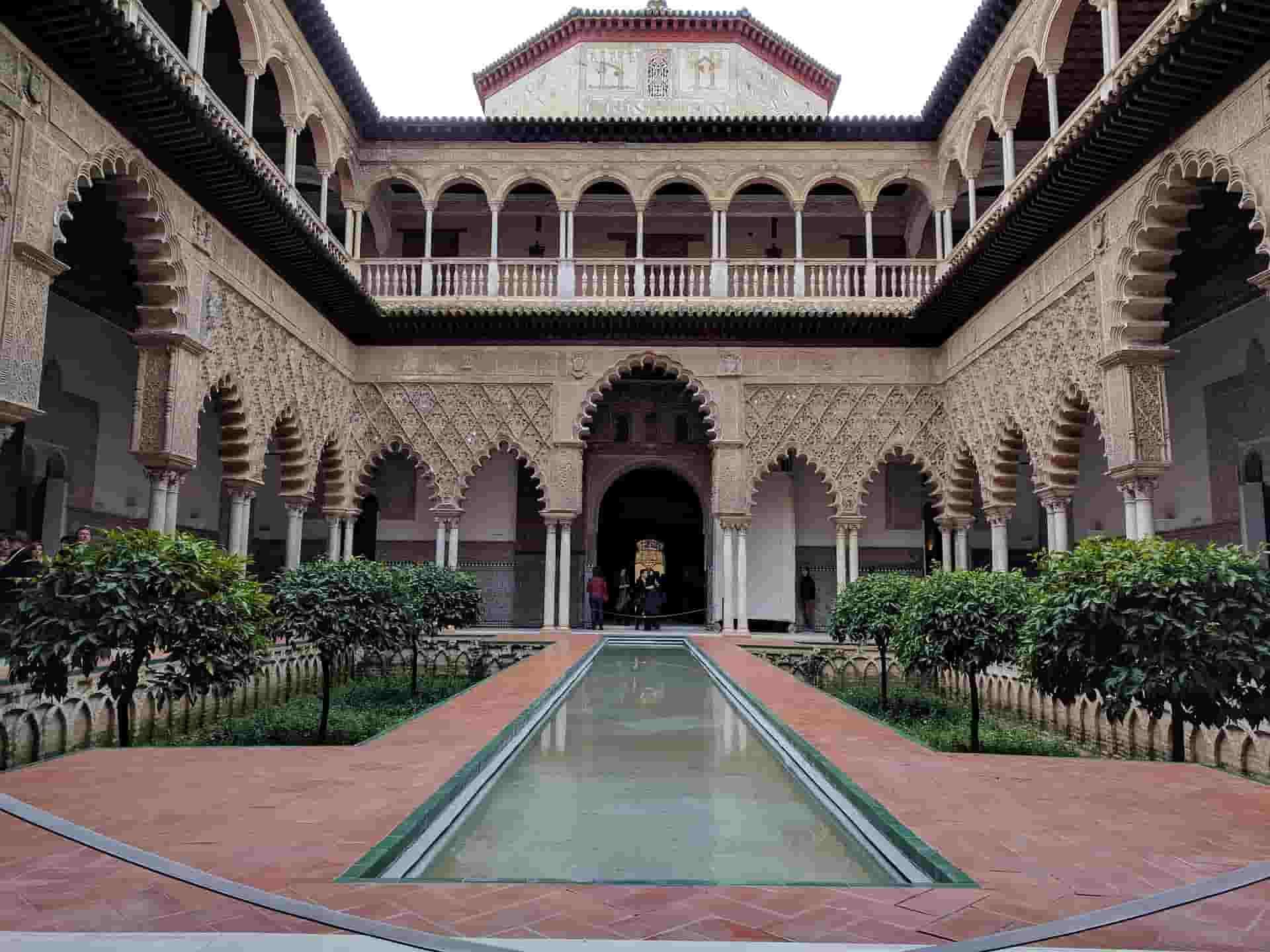 There is a fountain in the middle of the courtyard of a building.