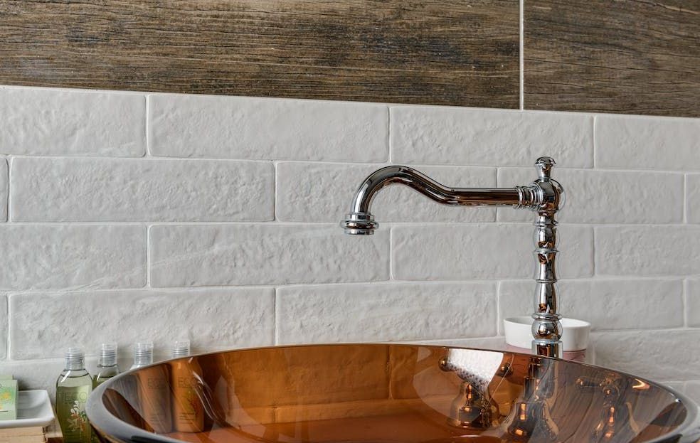 picture of a vessel sink with a trendy faucet