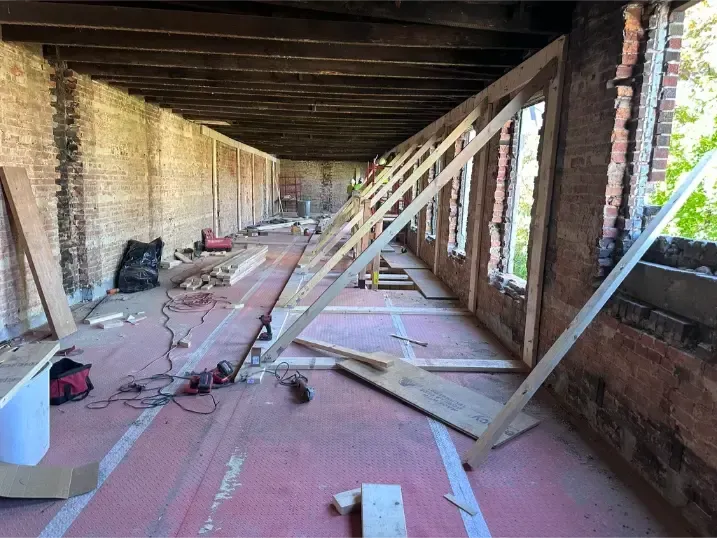 A brick wall crack repair with interior wood shoring