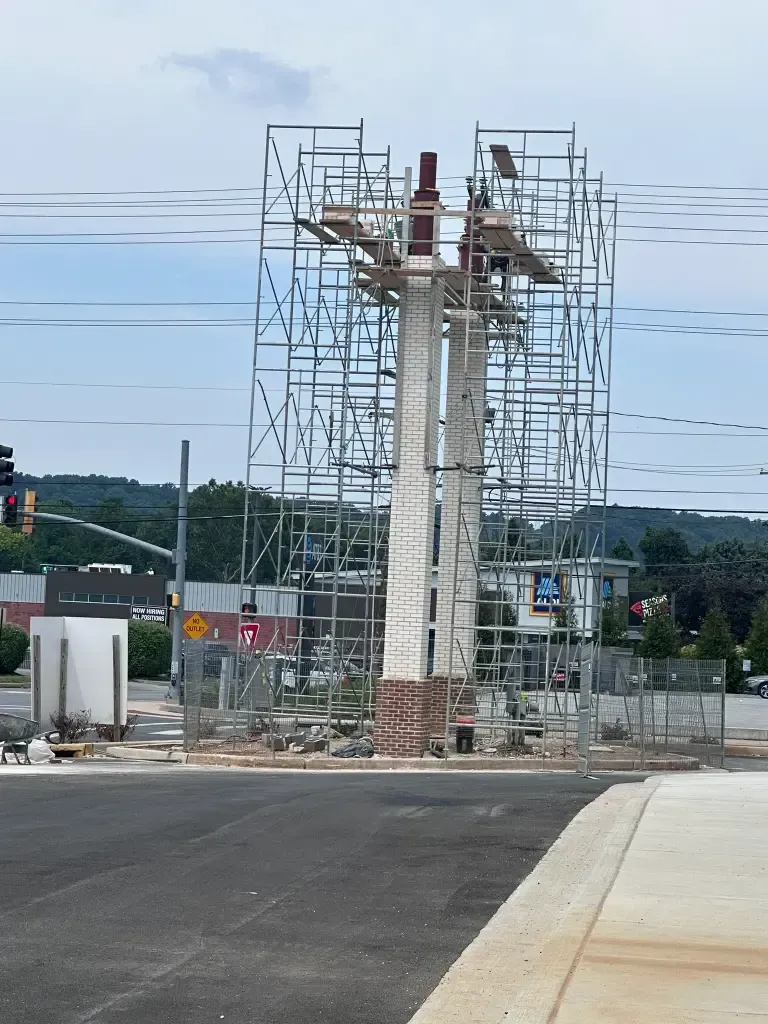 A masonry concrete restoration project using extensive scaffolding.