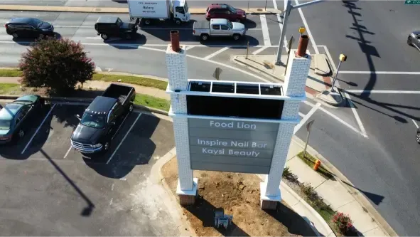 Alt Text:
Masonry concrete restoration of pillars for commercial signs.