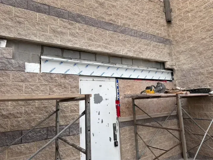 Alt Text:
Mortar joint repair during a structural lintel replacement.