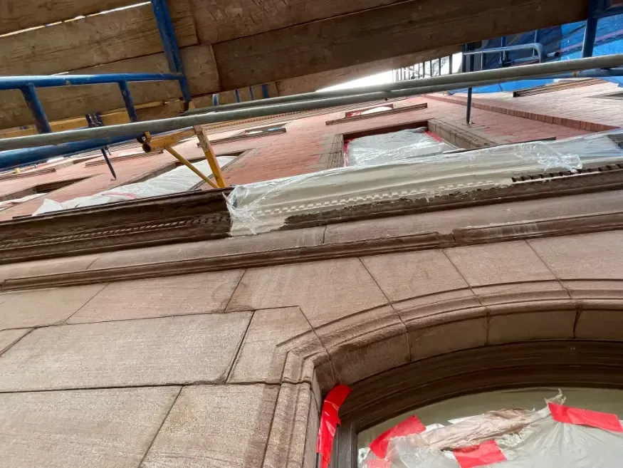 A lintel under construction with scaffolding on the side of it.