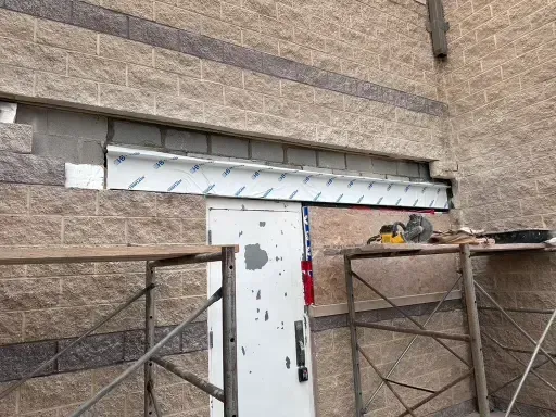 Structural brick repair with new steel lintel installation.