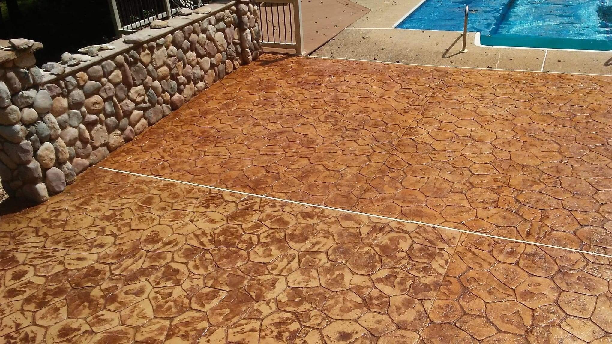 pool patio with hexagon stamped concrete
