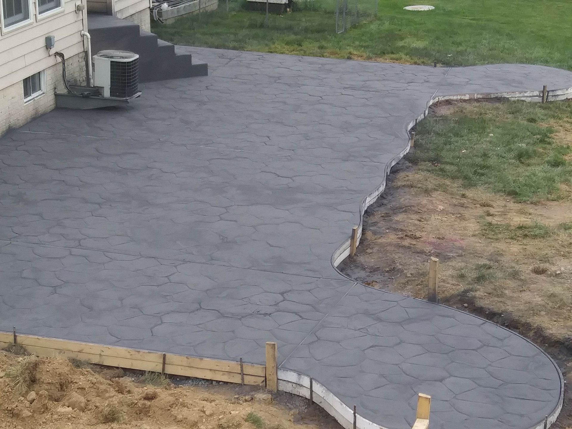 frshly black coated stamped concrete job results