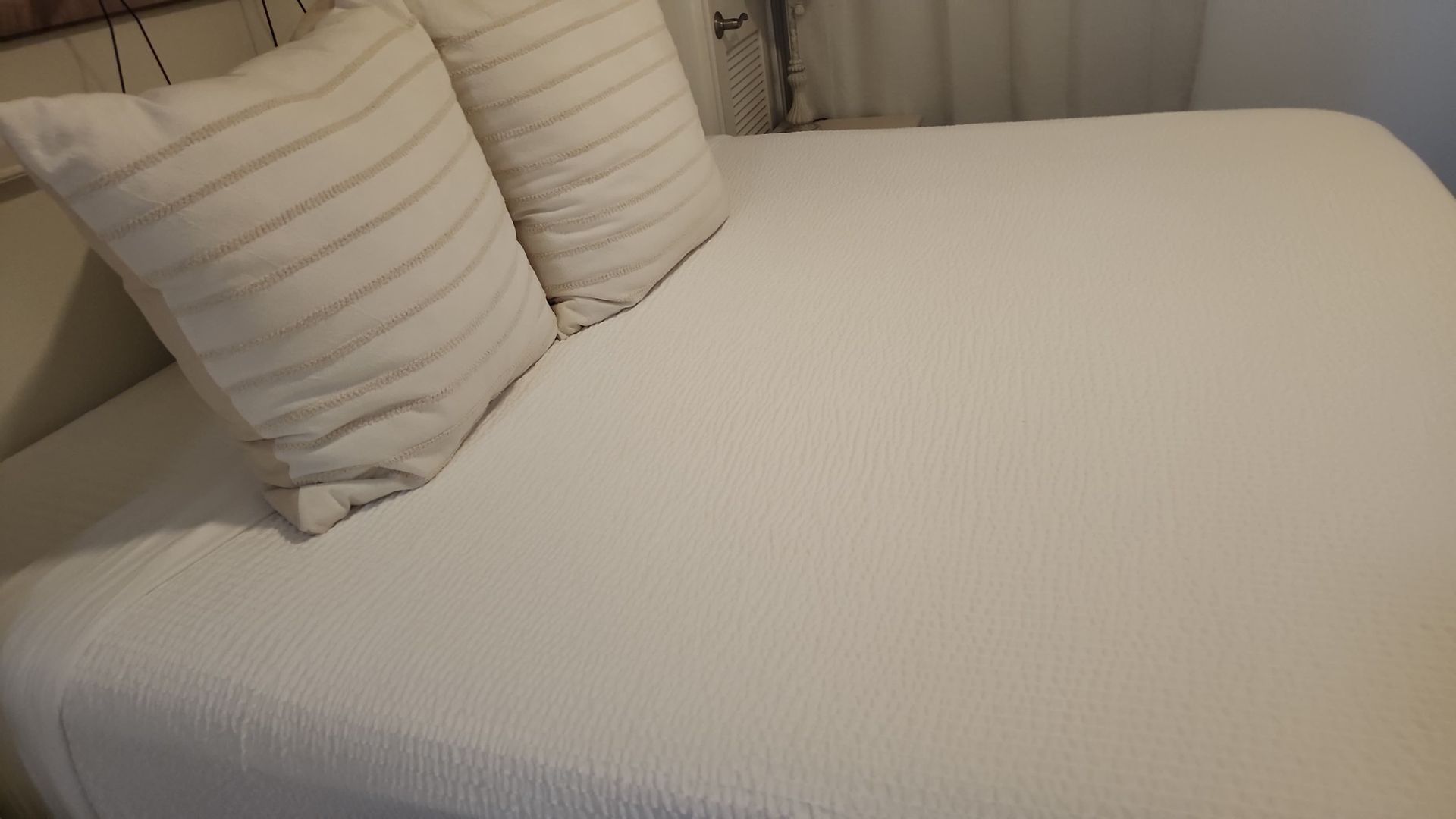White bed with two pillows.