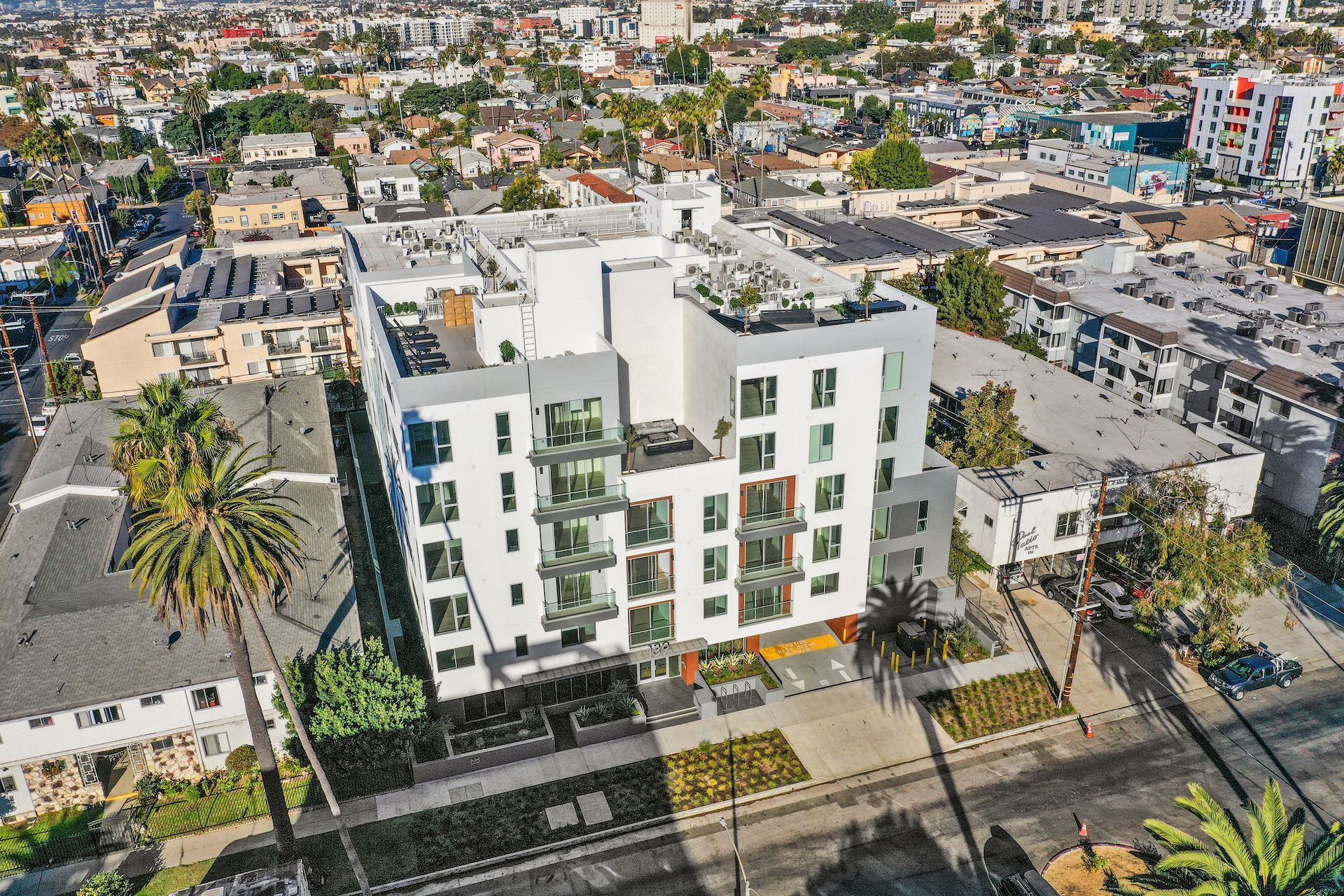 An aerial view of a large white building in the middle of a city.