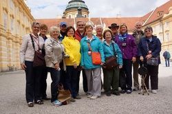 A group of people are posing for a picture in front of a building.