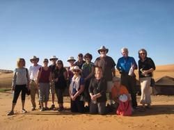 A group of people are posing for a picture in the desert.