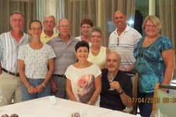 A group of people are posing for a picture in front of a table.