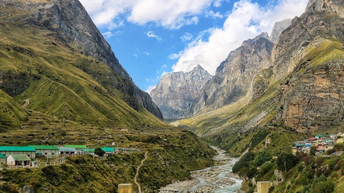 A river runs through a valley between two mountains.