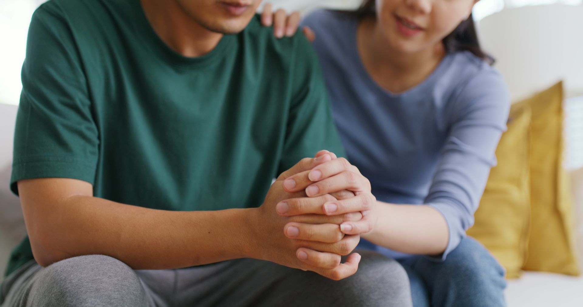 Angry woman with man trying to comfort woman