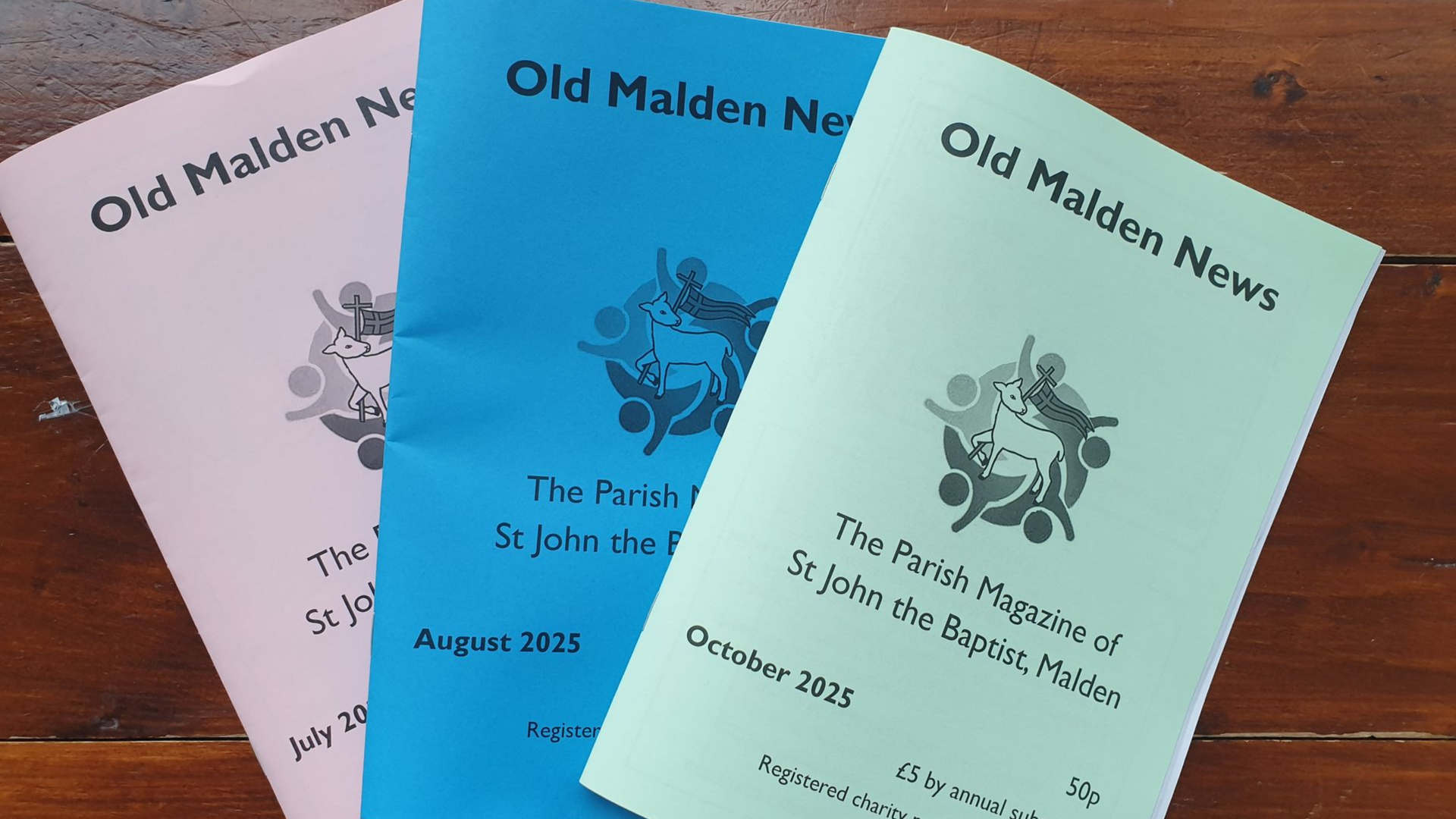 Three brochures titled "Old Malden News" in pink, blue, and green on wooden surface.