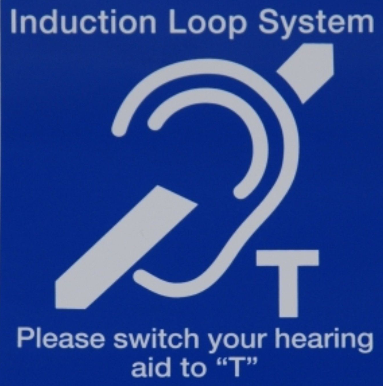 Blue sign with ear symbol, arrow, and