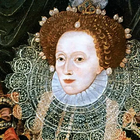 Queen Elizabeth I in ornate lace collar and jeweled crown.