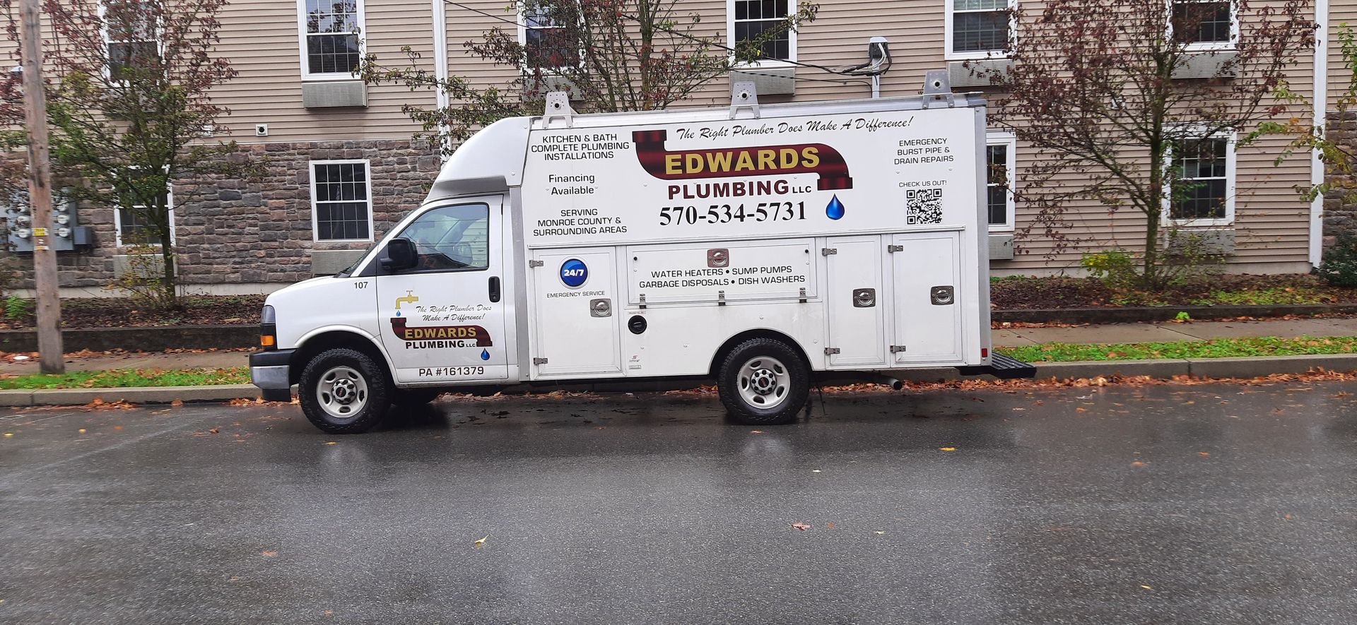 Edwards Plumbing Truck parked on the street in front of building