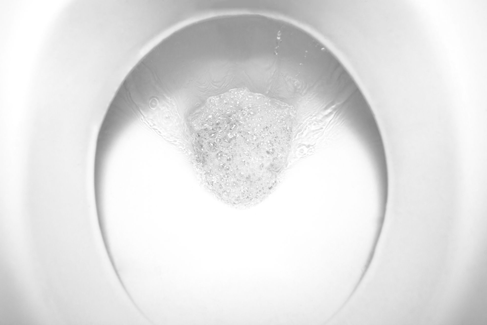 Toilet bowl with swirling water and bubbles. Toilet bowl with swirling water and bubbles.