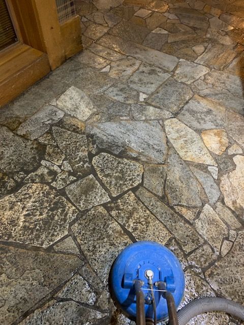 Blue Cleaning Gloves Holding A Sponge Cleaning A Tile Floor — Carson City, NV — Floor Masters